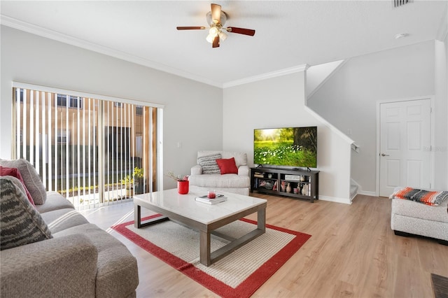 living room with light wood-type flooring, ceiling fan, and ornamental molding