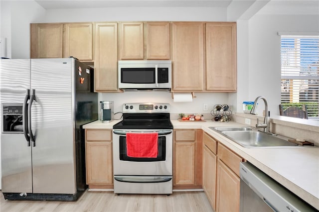 kitchen featuring light hardwood / wood-style floors, light brown cabinetry, sink, and appliances with stainless steel finishes