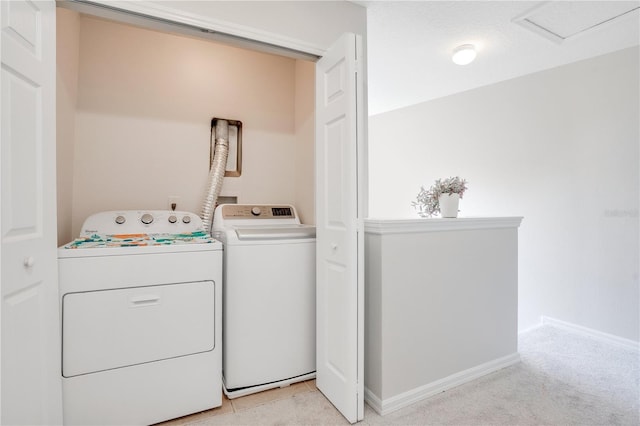 laundry area featuring light carpet and washing machine and clothes dryer