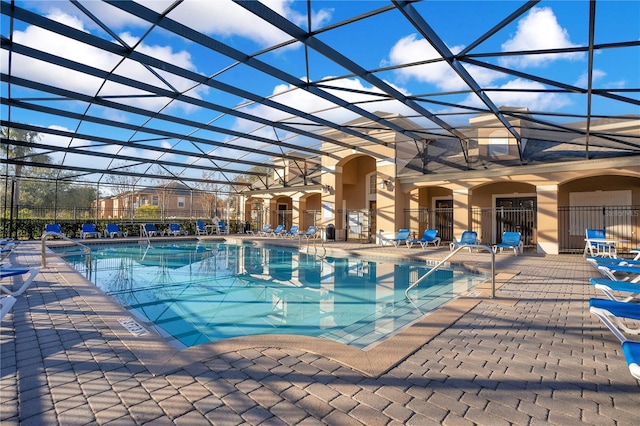 view of swimming pool with a patio and a lanai