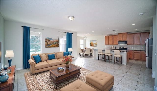 tiled living room featuring plenty of natural light and sink