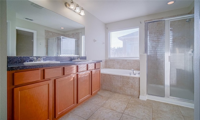 bathroom with tile patterned floors, vanity, and separate shower and tub