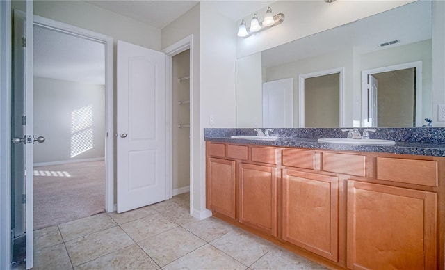 bathroom featuring tile patterned flooring and vanity