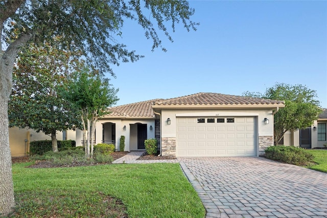 view of front of house with a garage and a front lawn