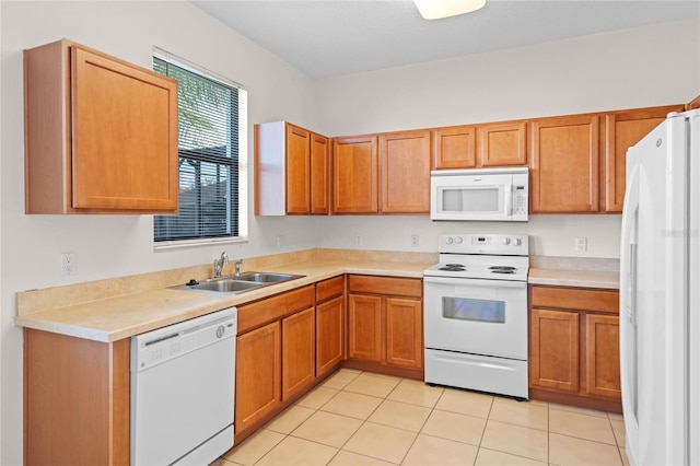 kitchen with sink, white appliances, and light tile patterned floors