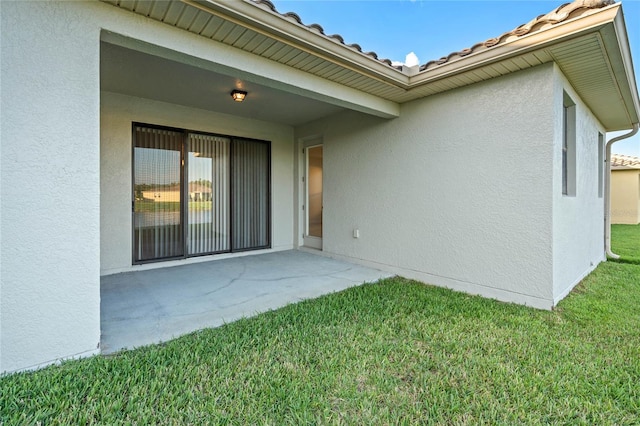 exterior space featuring a patio and a lawn