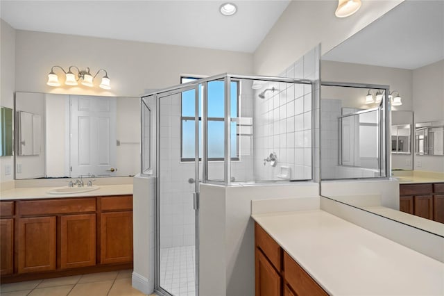 bathroom with tile patterned flooring, walk in shower, and vanity