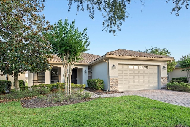 mediterranean / spanish-style home with a garage and a front lawn