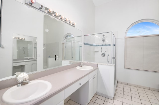 bathroom featuring tile patterned flooring, a towering ceiling, vanity, and a shower with door