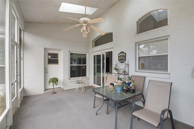 sunroom / solarium featuring a skylight and ceiling fan