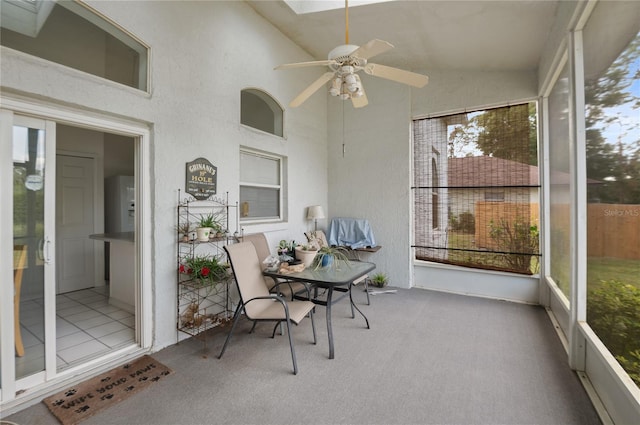 sunroom / solarium with ceiling fan and lofted ceiling