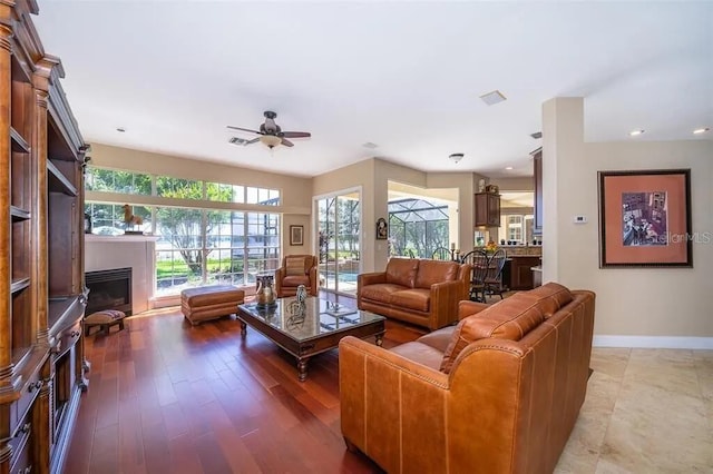 living room with ceiling fan and hardwood / wood-style floors