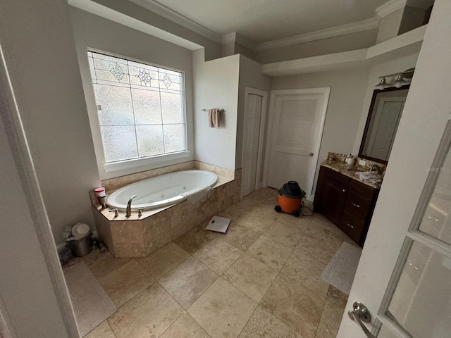 bathroom featuring vanity, ornamental molding, and tiled tub