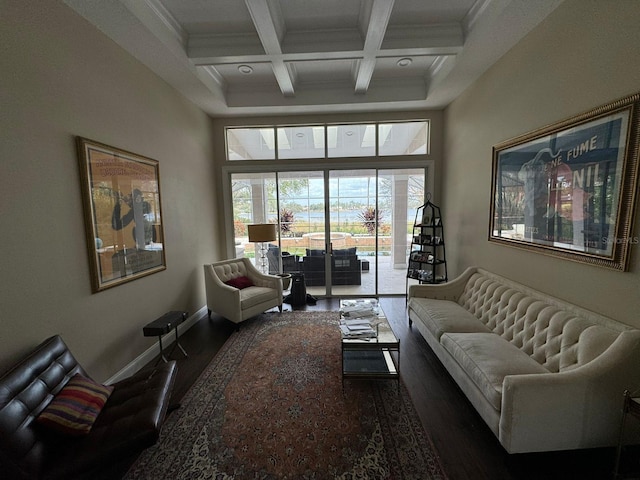 living room with beamed ceiling, dark hardwood / wood-style flooring, ornamental molding, and coffered ceiling