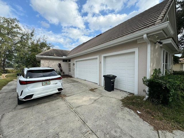 view of side of property with a garage