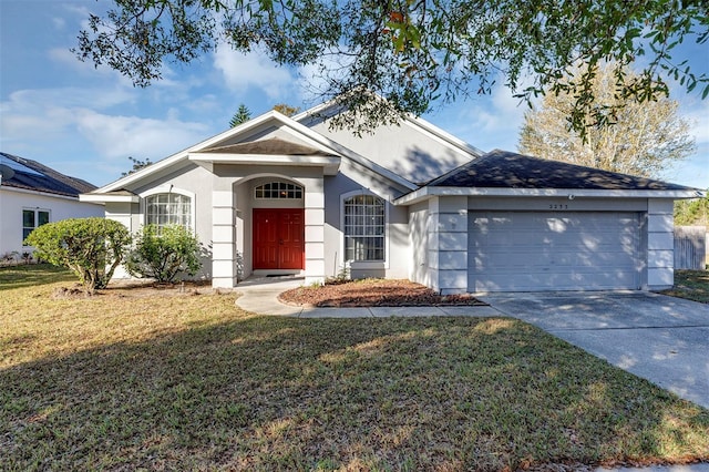 ranch-style home featuring a front yard and a garage