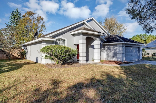 single story home featuring a front yard and a garage