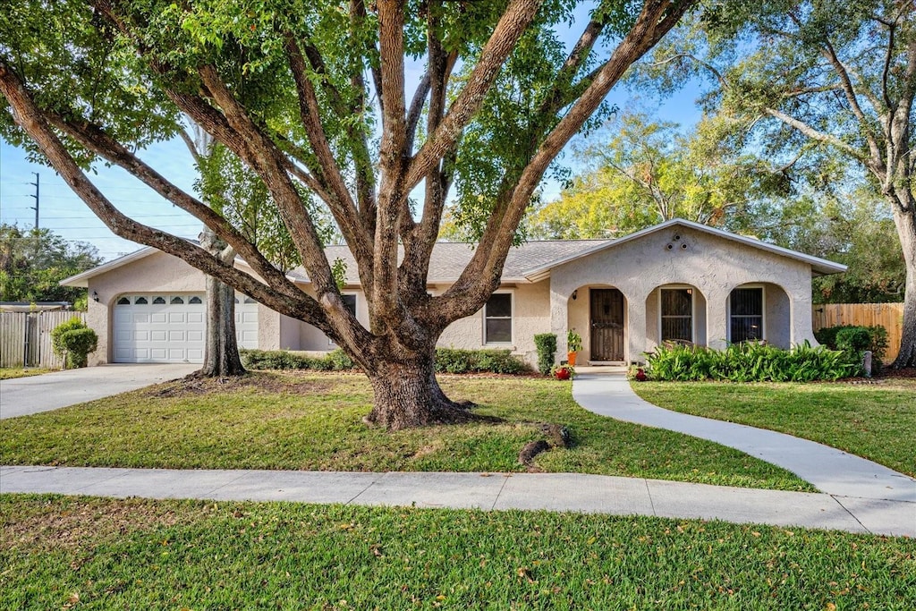 single story home with a front lawn and a garage