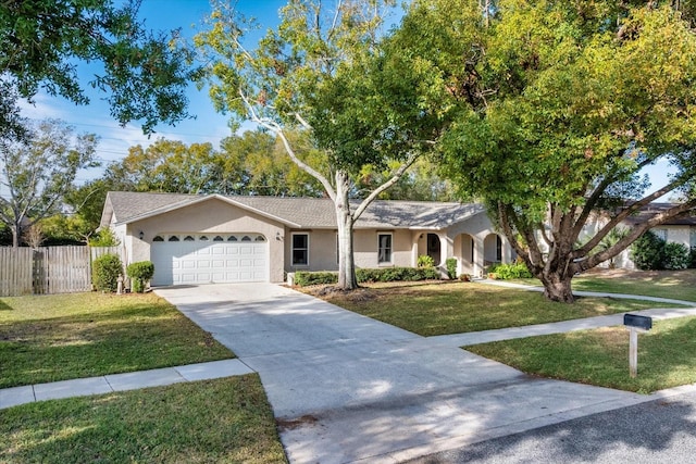 single story home featuring a garage and a front lawn