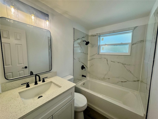 full bathroom featuring toilet, vanity, and tiled shower / bath