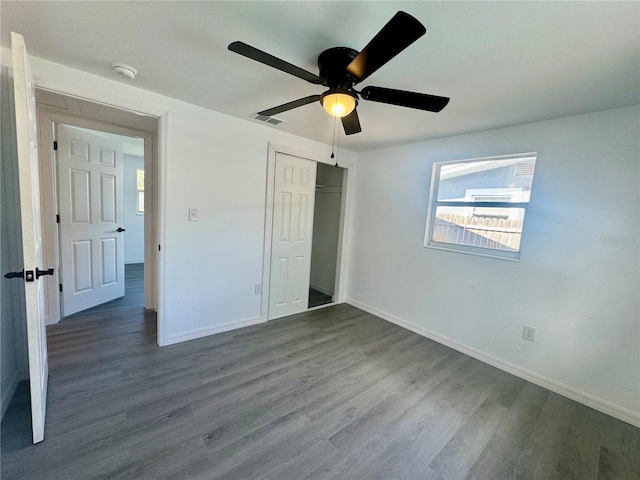 unfurnished bedroom with ceiling fan, wood-type flooring, and a closet