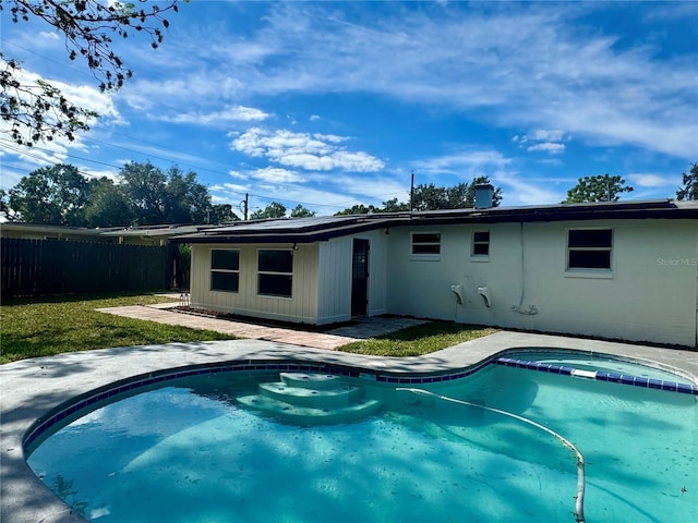 view of swimming pool with a lawn