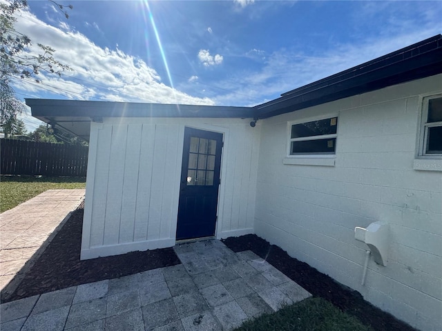 view of exterior entry featuring a patio area