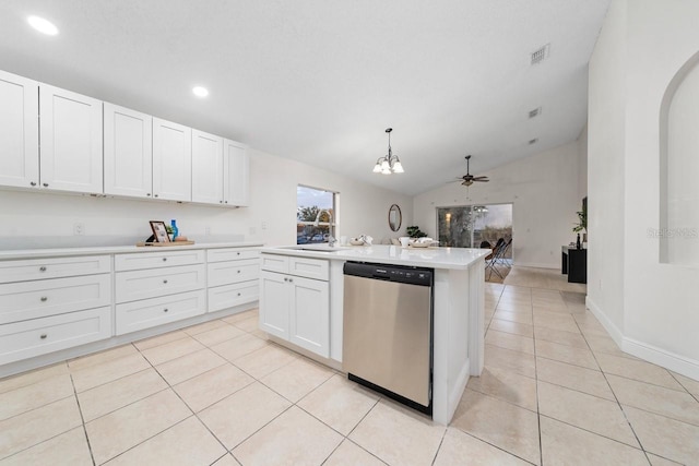 kitchen featuring white cabinets, stainless steel dishwasher, hanging light fixtures, and lofted ceiling