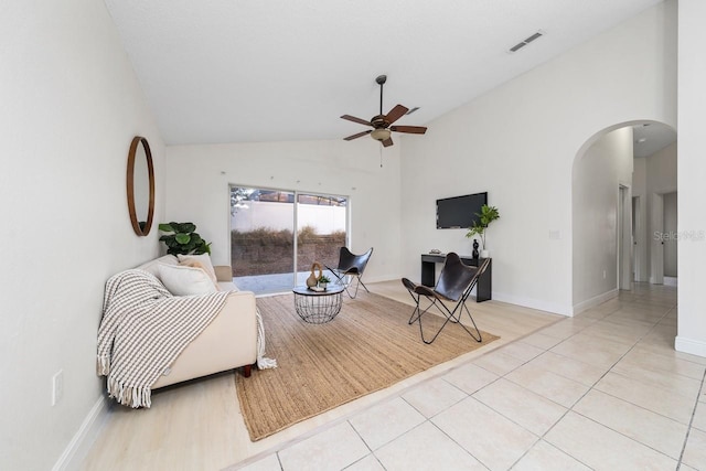 tiled living room with high vaulted ceiling and ceiling fan