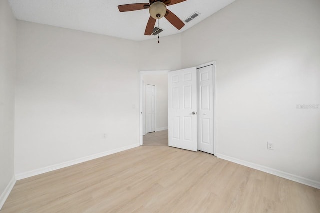 spare room with ceiling fan and light wood-type flooring