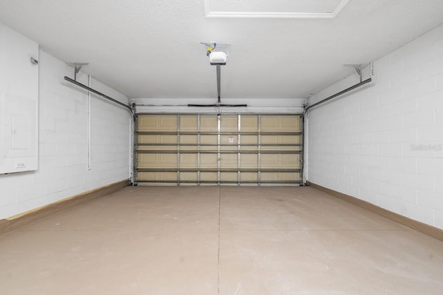 garage with electric panel and a garage door opener