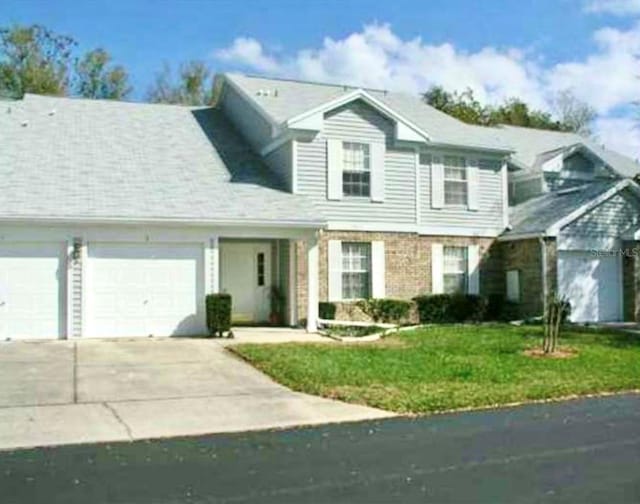 view of property with a front yard and a garage