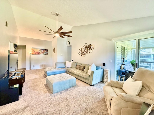 living room with light colored carpet, vaulted ceiling, and ceiling fan