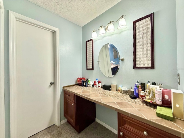 bathroom featuring a textured ceiling and vanity