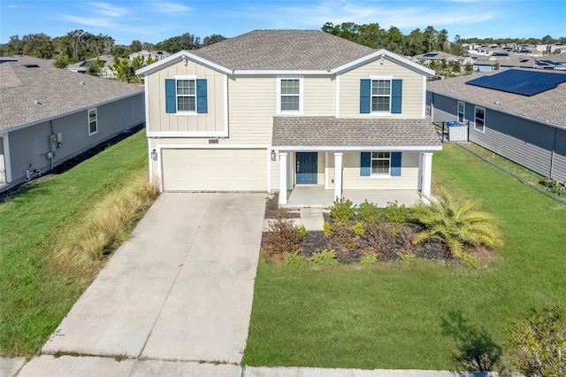 view of front of house with a garage and a front lawn