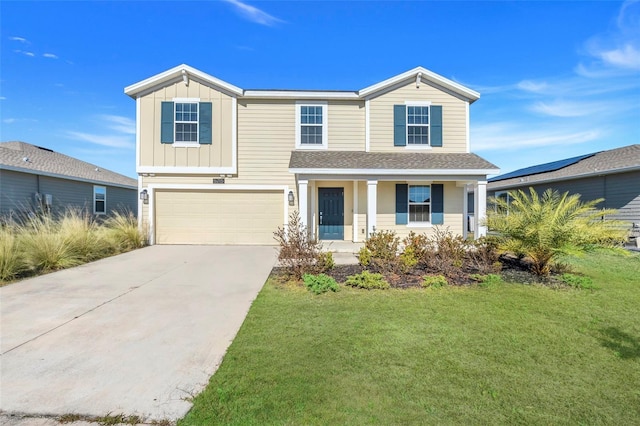 view of front of home featuring covered porch, a front lawn, and a garage