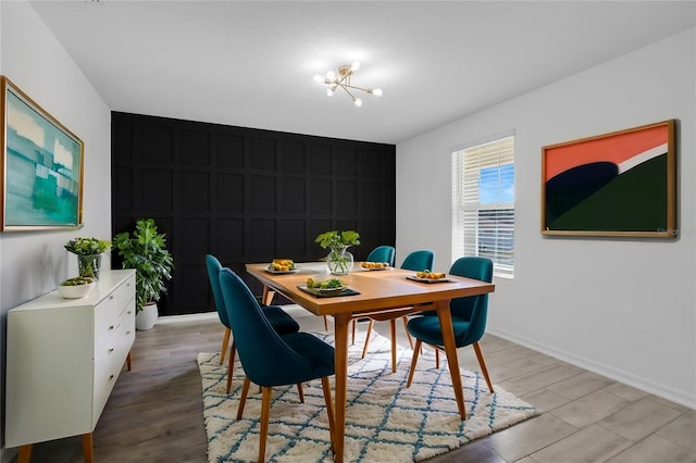 dining space with a notable chandelier and light hardwood / wood-style floors