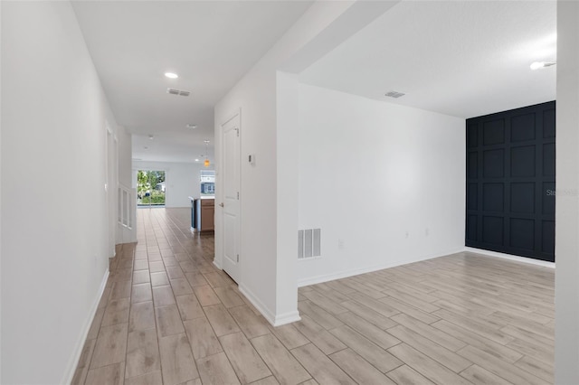 hall with light wood-type flooring