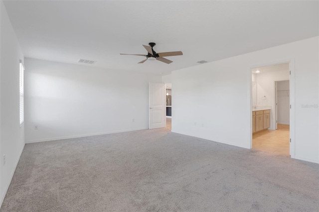 carpeted spare room with ceiling fan