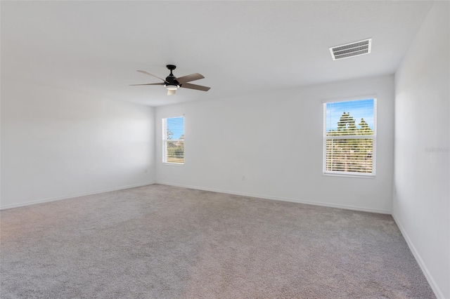 spare room with light carpet and ceiling fan