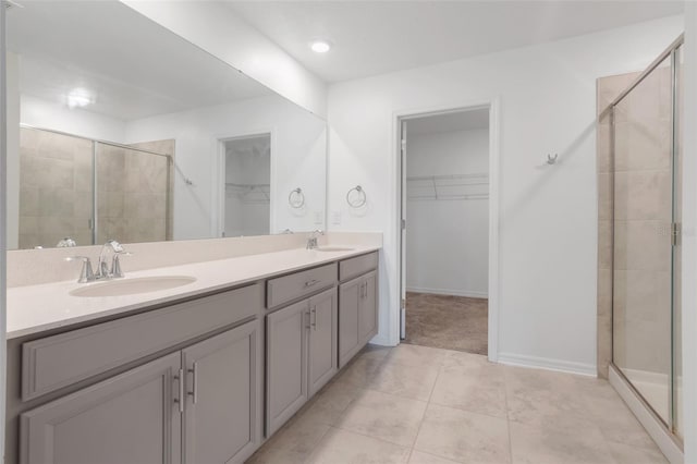 bathroom featuring vanity, tile patterned floors, and a shower with shower door