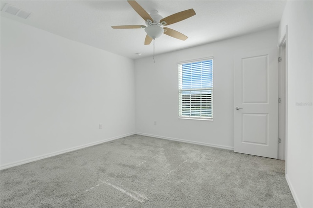 unfurnished room featuring light carpet and ceiling fan