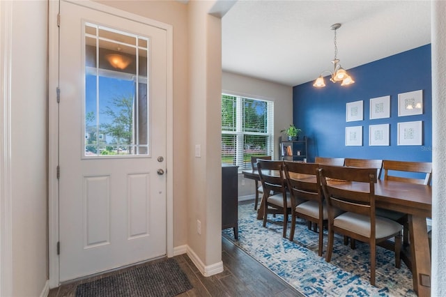 dining room with a chandelier and dark wood-type flooring