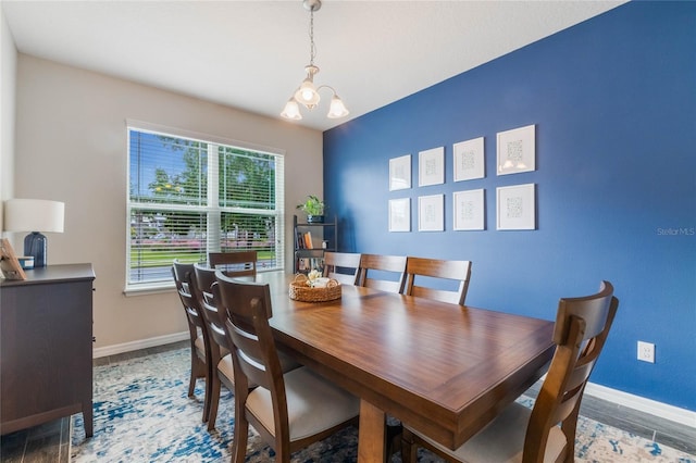 dining room with a notable chandelier and dark wood-type flooring