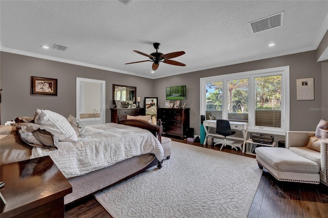 bedroom featuring dark wood-type flooring, a textured ceiling, connected bathroom, and ceiling fan