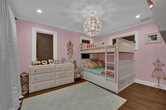 bedroom with crown molding, a chandelier, and dark hardwood / wood-style flooring