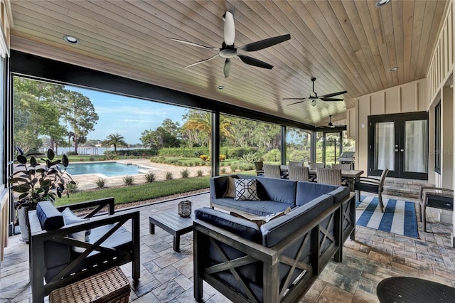 view of patio / terrace featuring ceiling fan, an outdoor living space, and french doors