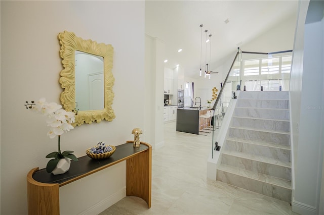 stairway with lofted ceiling and sink