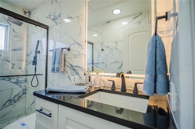 bathroom with vanity, tile walls, and tiled shower