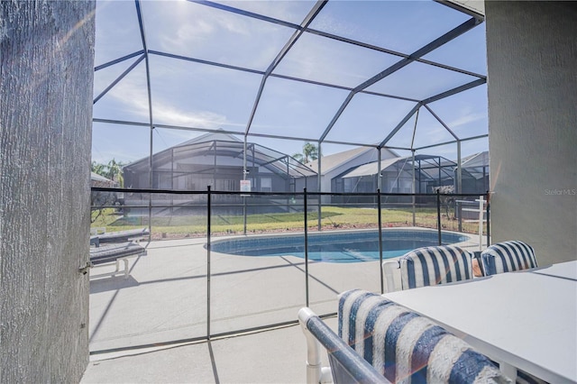 view of patio featuring a lanai